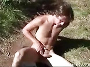 Naked boy working his cock by the lake