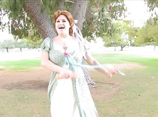 Busty redhead hussy fucks her twat with a dildo in a park