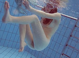 Solo model with the red hair decides to get naked under the water