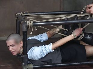 Bald slut simply enjoys being restrained in the dungeon