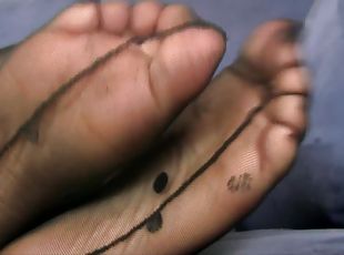 Zoomed in view of a babe's hot feet in some sexy nylon