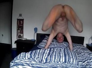 Naked man bouncing on the bed