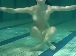 Smooth and slender teen swims in the pool