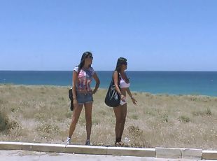 Three sexy chicks in bikinis go lesbian at a beach