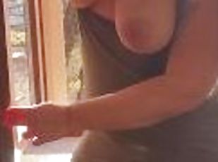 Exhibitionist wife cleaning windows topless. Sexy milf flashing boo...