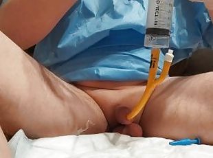 Filling the bladder with saline solution with a 30FR catheter, urin...