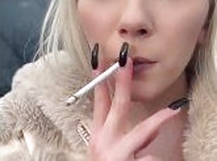 A glamour teen is smoking and spitting loogies on the ground making...