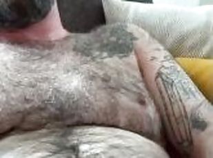 Hairy dad sits back and strokes on the couch, grunting, teasing and...