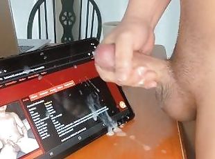 thick cock asian guy cums on a tablet and scrolls the page with his...