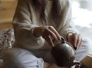 A girl filling tea into a classic cup