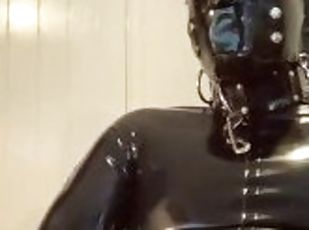 Gagged rubber gimp jerks off