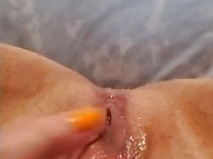 Amateur rubs clit and pussy, squirts fountain