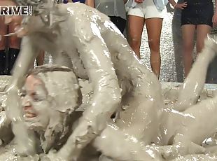 Wild brunette with a slim sexy body having a catfight in a mudbath