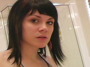 Hot babe with long dark hair applying makeup in her bathroom