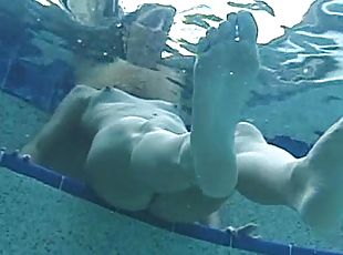 Brunette milf enjoys playing with some guy's dick in a pool