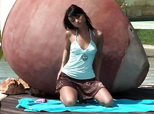 Kinky brunette masturbating her vagina near a pool