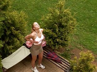 Blonde gets her out out and fucks herself in the garden