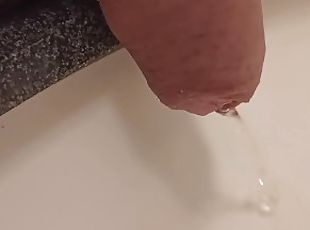 close up pee in sink. uncutted