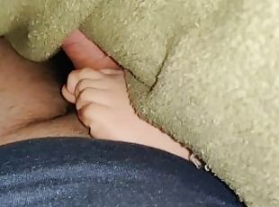 My stepsister gives a footjob under the blankets while watching a m...