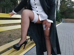 Slut walking in the park in a raincoat and black fishnet stockings ...