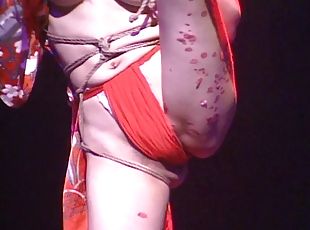 Marvelous Japanese chick in bondage entertains a crowd of people in this live on stage scene