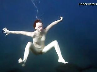 Redheaded girl is so sexy naked in the water