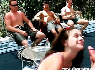 Teen gives blowjob as guys watch outdoors