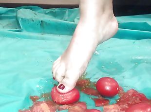 Barefoot food crushing, smashing tomatoes and crispy cake with my s...