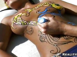 Two hot chicks with bodyart enjoy smashing each other's vags with toys