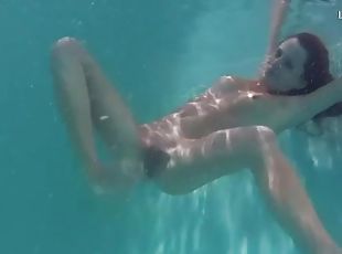 Slim redhead in bikini gets naked underwater