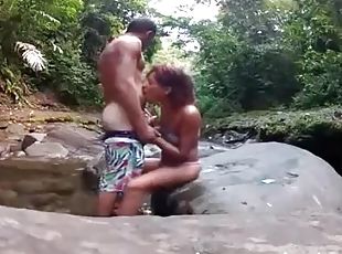 Amateur couple fucks on a rock in the river