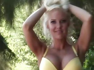 Blonde with bodacious fake tits strips outdoors