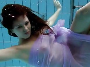 Purple dress falls off brunette in the pool