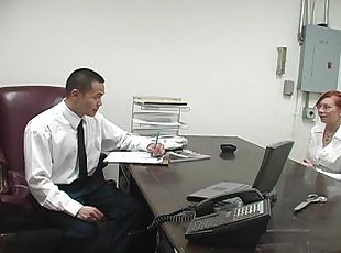 Tattooed redhead sucking her employer's cock in his office