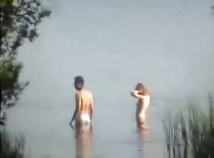 Homemade video of a couple swimming naked and fucking in the lake