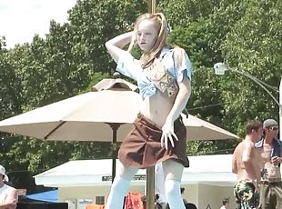 Amateur blonde dances striptease at a party on the poolside