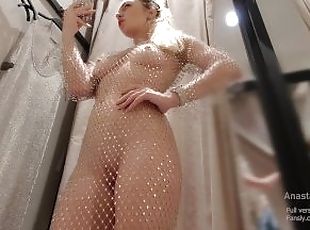 I try on transparent dress in fitting room with open curtain. Peopl...