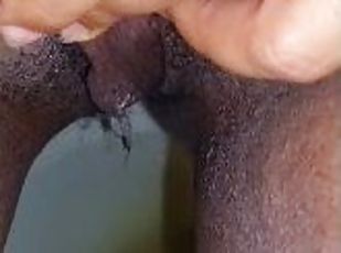 Horny black girl records this video while she urinates in the bathr...