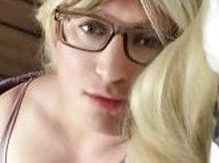 Sexy blonde trans milf wearing glasses poses in lingerie on bed