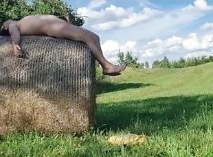 A chub cums outside after playing with a thong on a hay bale