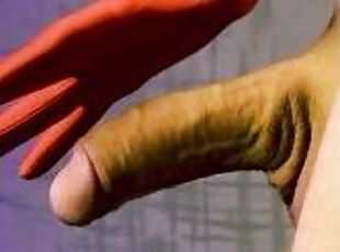 Man masturbates cock in red gloves